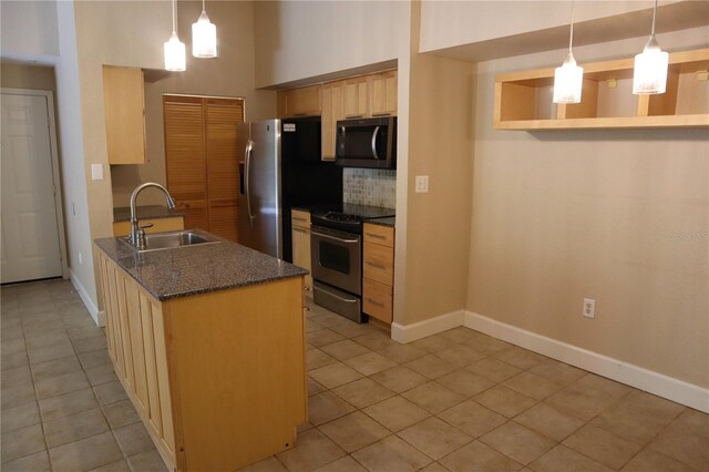 kitchen featuring sink, tasteful backsplash, hanging light fixtures, light brown cabinets, and stainless steel appliances