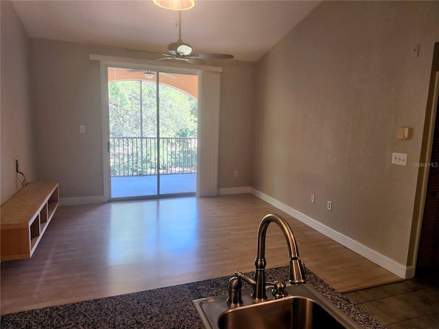 interior space with ceiling fan, sink, and light hardwood / wood-style floors