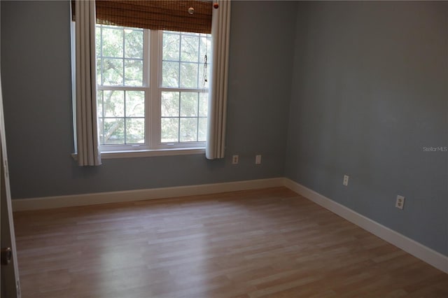 empty room with light hardwood / wood-style flooring