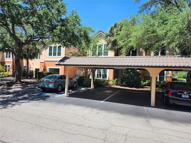 view of parking / parking lot featuring a carport