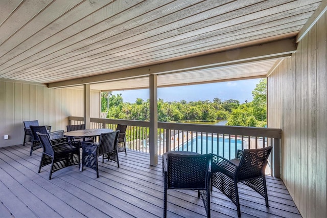 sunroom / solarium featuring beam ceiling