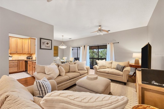 living room featuring ceiling fan and light hardwood / wood-style flooring