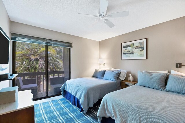 bedroom with access to outside, a textured ceiling, and ceiling fan