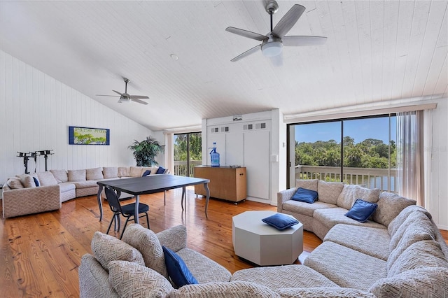 living room featuring ceiling fan, light hardwood / wood-style flooring, and wooden ceiling