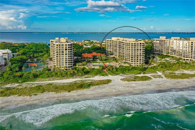 bird's eye view with a water view and a beach view