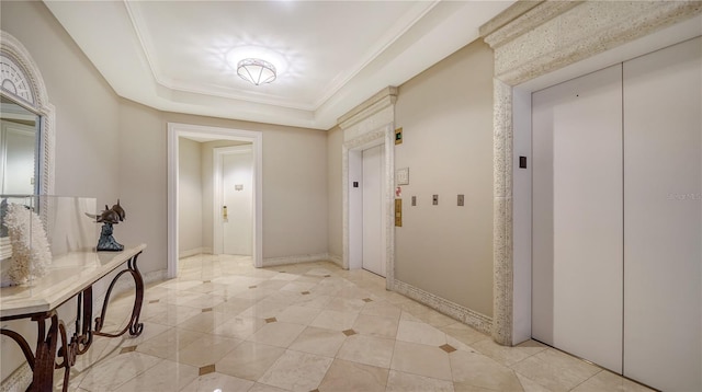 interior space with crown molding, a raised ceiling, and elevator