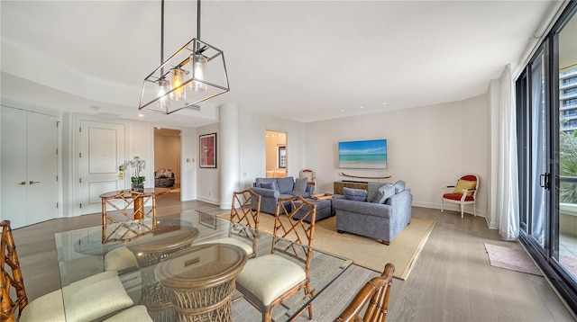 living room with a chandelier and wood-type flooring