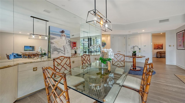 dining space featuring wood-type flooring