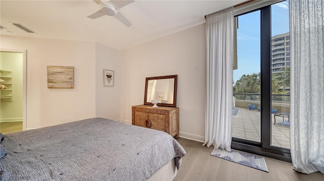 bedroom featuring ceiling fan, access to outside, and light hardwood / wood-style flooring