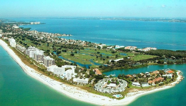 aerial view with a water view and a view of the beach