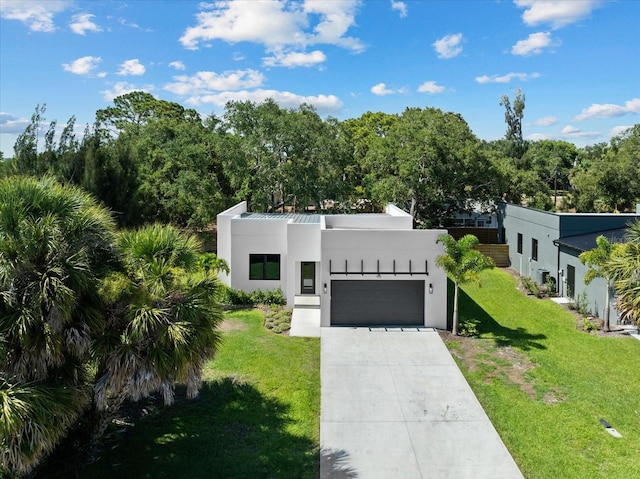 contemporary house with a garage and a front lawn