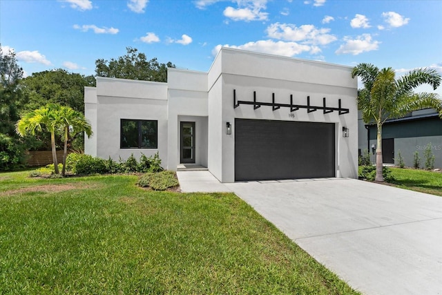 modern home featuring a garage and a front lawn