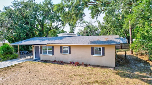 ranch-style home with a front lawn