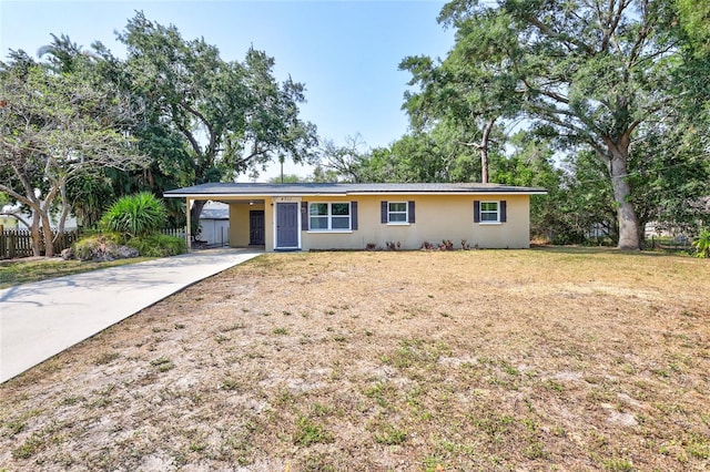 ranch-style house with a front yard and a carport