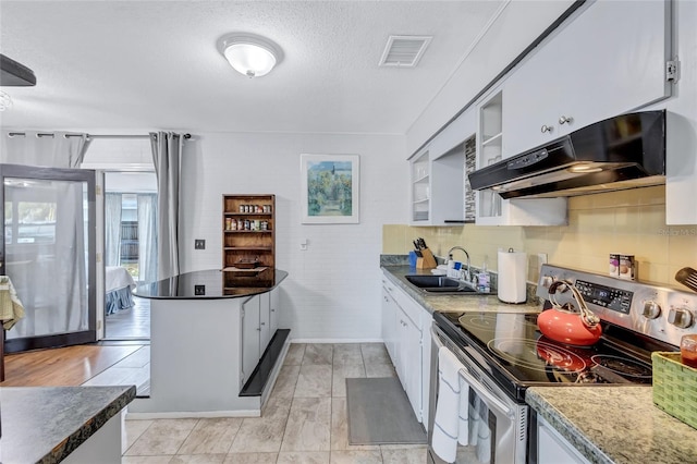 kitchen with stainless steel electric range, sink, white cabinetry, and light tile flooring