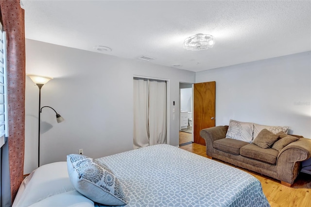 bedroom featuring a closet and hardwood / wood-style flooring