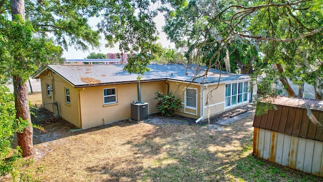 rear view of house featuring central air condition unit