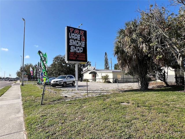 community sign featuring a lawn