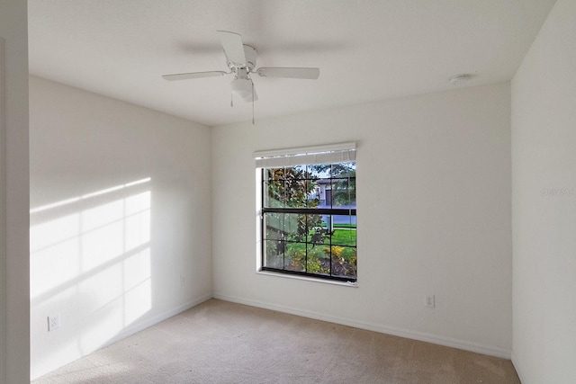 spare room featuring carpet flooring and ceiling fan