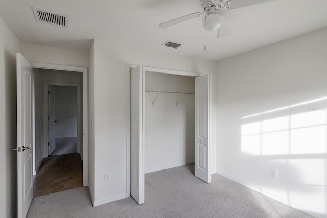 unfurnished bedroom with carpet, ceiling fan, and a closet