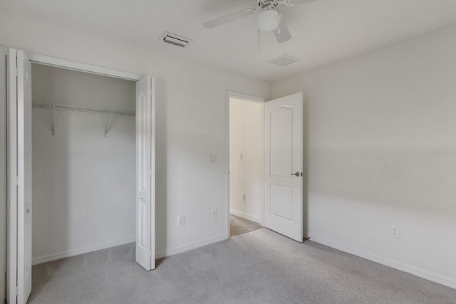 unfurnished bedroom with carpet, ceiling fan, and a closet