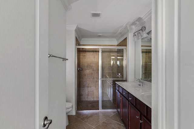 bathroom featuring dual bowl vanity, toilet, tile floors, ornamental molding, and walk in shower