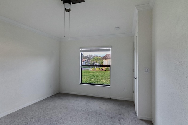 carpeted spare room with crown molding and ceiling fan