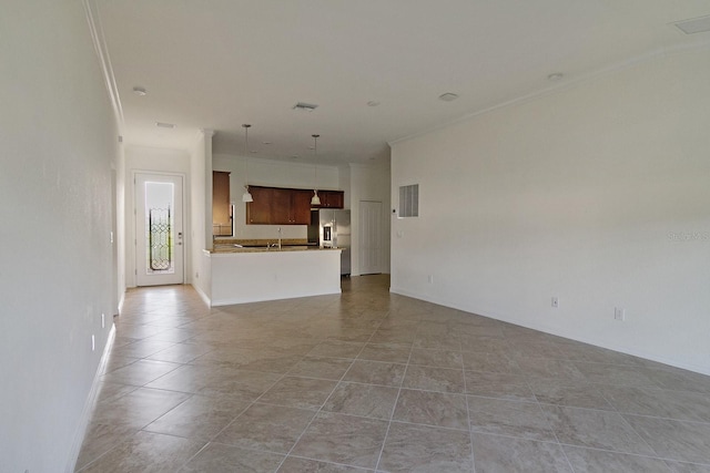 unfurnished living room featuring sink and light tile flooring