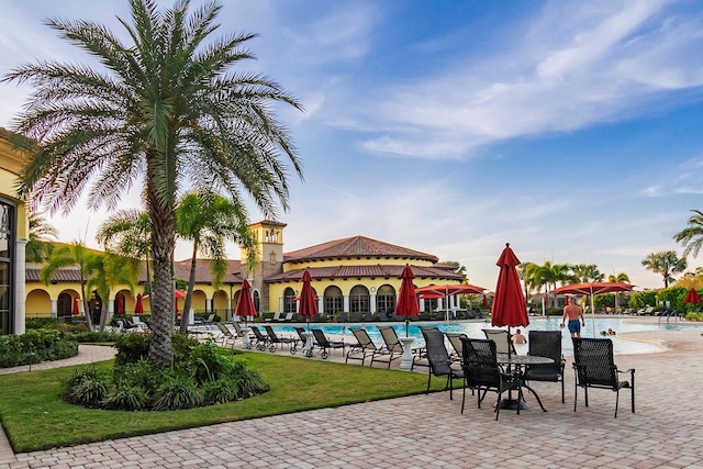 view of home's community with a swimming pool and a patio