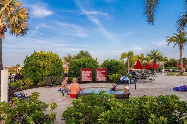 view of playground featuring a patio