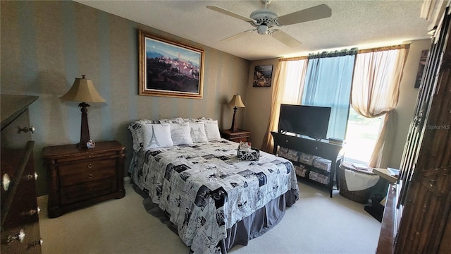 carpeted bedroom featuring a textured ceiling and ceiling fan