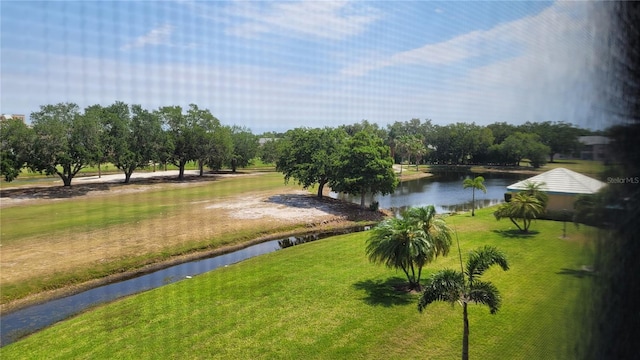 view of property's community featuring a water view and a lawn