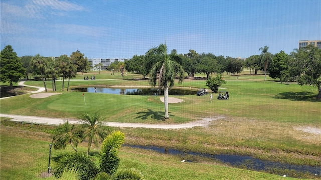 view of community featuring a lawn and a water view