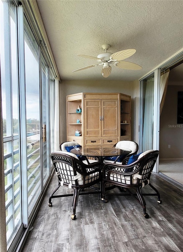 dining space with hardwood / wood-style floors, a textured ceiling, and ceiling fan