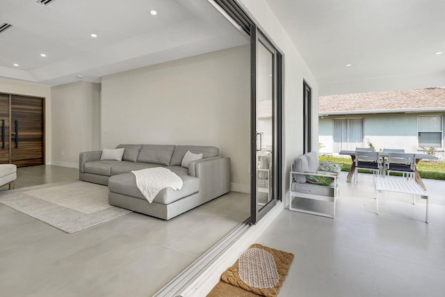 living room featuring a raised ceiling