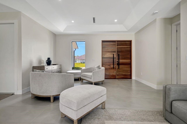 tiled living room with a tray ceiling