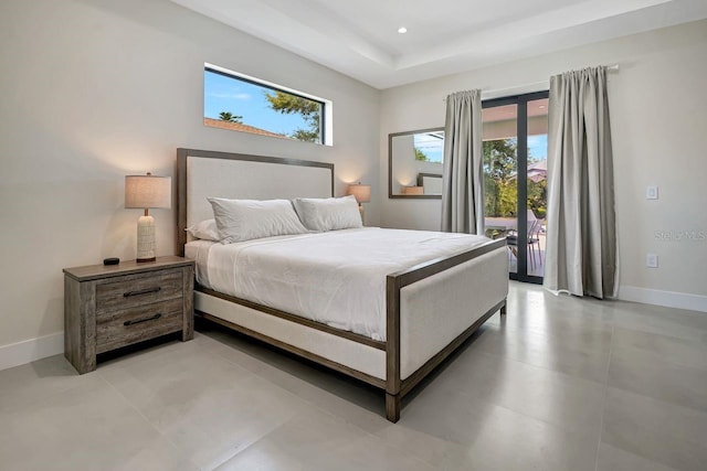 tiled bedroom with a tray ceiling and access to outside