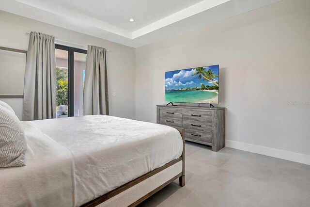 tiled bedroom with a tray ceiling