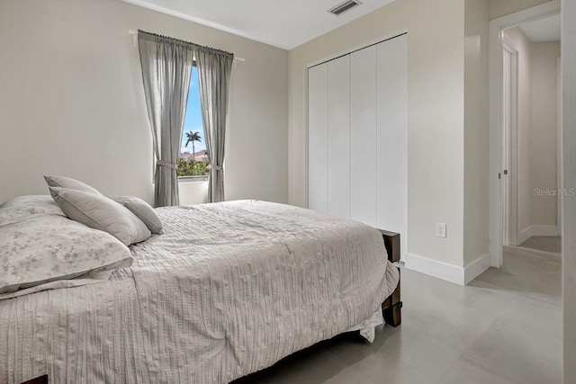 bedroom featuring tile flooring and a closet