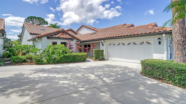 mediterranean / spanish-style house with a garage