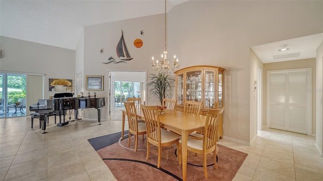 dining space featuring a healthy amount of sunlight, a notable chandelier, and light tile floors