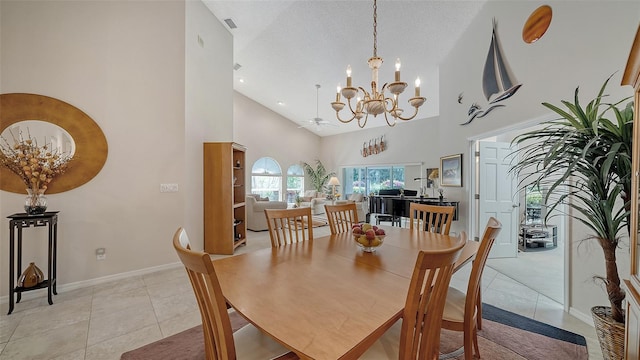 tiled dining space featuring high vaulted ceiling, an inviting chandelier, and a textured ceiling