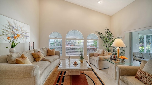 living room with high vaulted ceiling and plenty of natural light