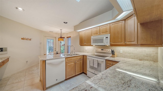 kitchen with tasteful backsplash, white appliances, pendant lighting, light tile floors, and sink