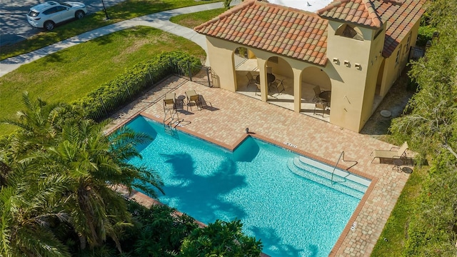 view of pool with a yard and a patio