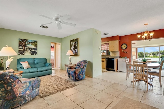 living room featuring light tile floors and ceiling fan with notable chandelier