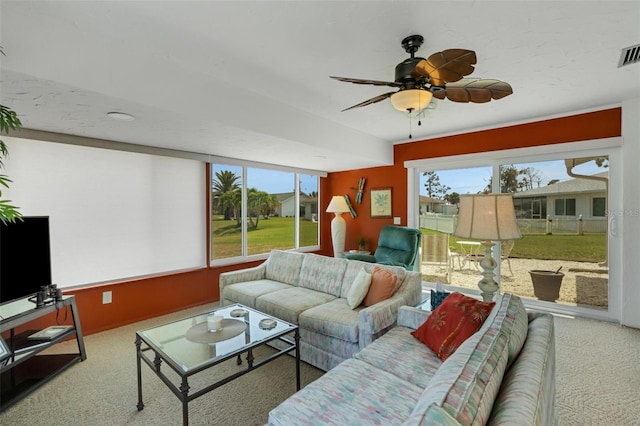 living room featuring carpet flooring and ceiling fan