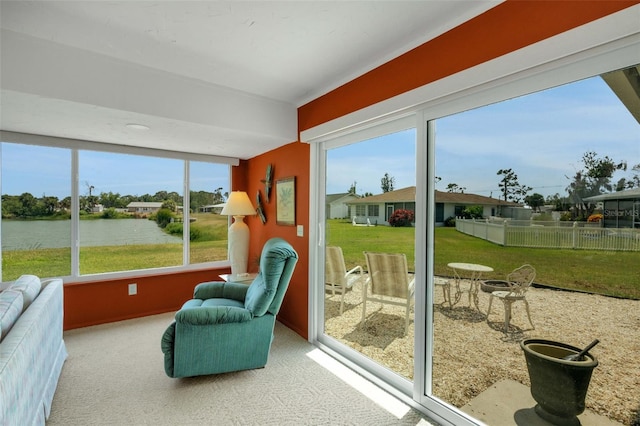 sunroom / solarium with plenty of natural light and a water view