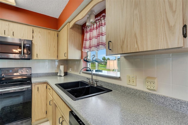 kitchen with a textured ceiling, stainless steel appliances, sink, tasteful backsplash, and light brown cabinets