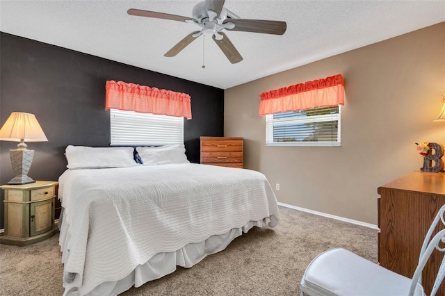 carpeted bedroom featuring ceiling fan and multiple windows